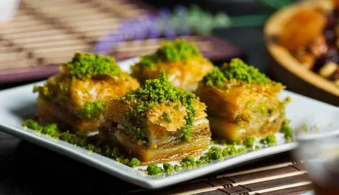 Vier Stück Pistazien-Baklava auf einem Teller